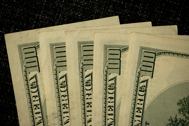 several dollar bills next to each other on a table