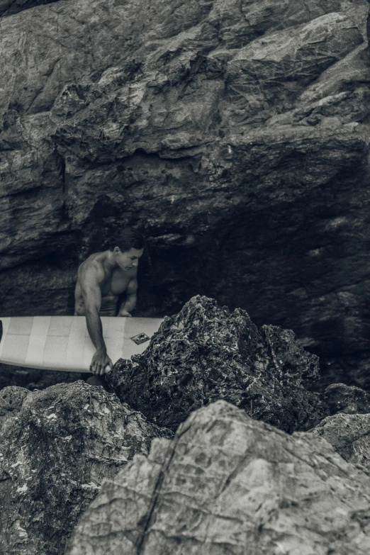 black and white image of surfers in a cave