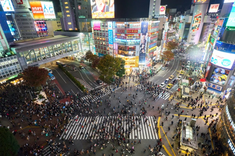 a busy intersection in the middle of a city at night