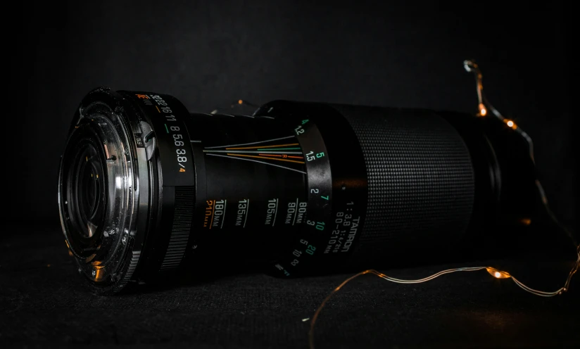 a large camera lens sits on the ground