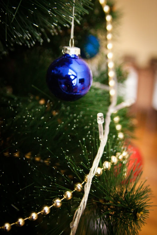 ornaments hanging from a christmas tree as seen from below