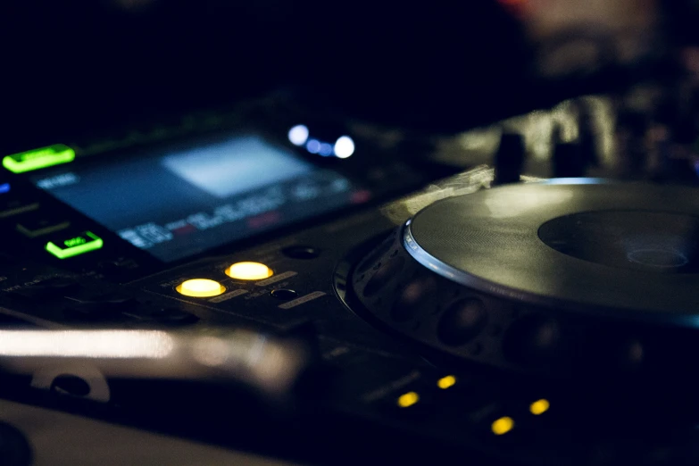 a dj player controls the drum set in front of a cell phone