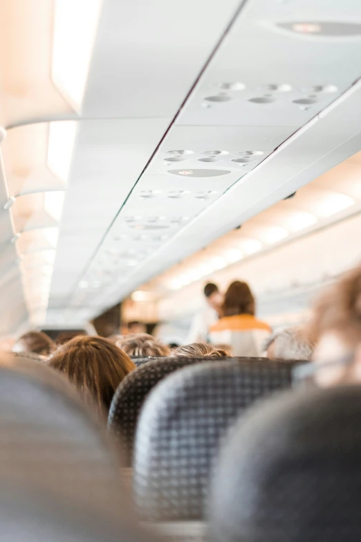 the interior of an airplane and people on the seat