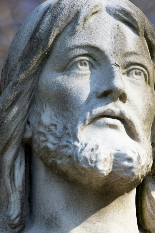 a statue of jesus looking at soing with a serious look on his face