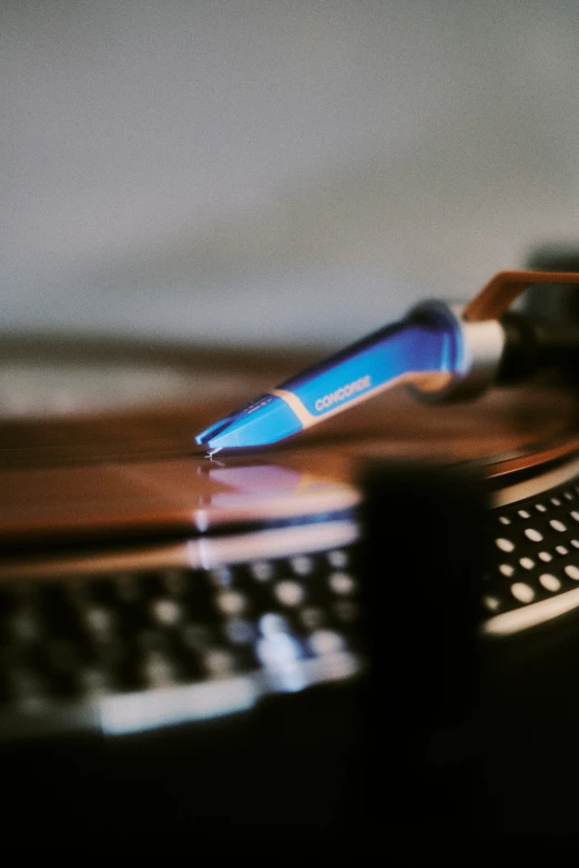 an open blue bottle sitting on top of a keyboard