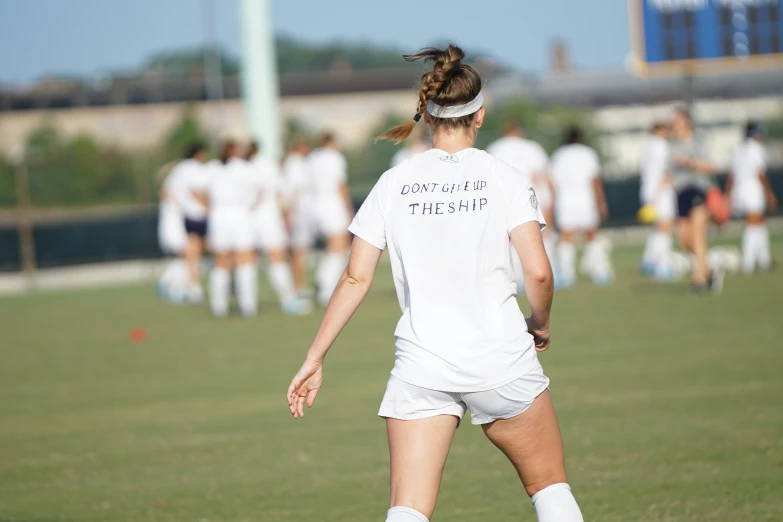 a soccer player in white wearing a white uniform