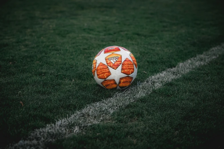 soccer ball on grass field during daytime with white line