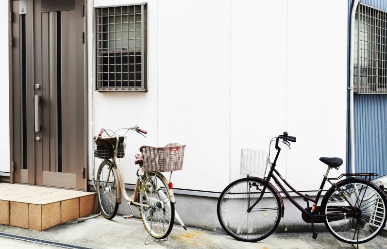 two bicycles sitting next to each other outside a house