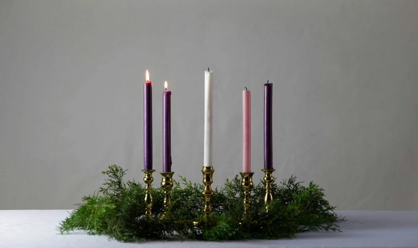 purple candles with white and pink sticks are displayed