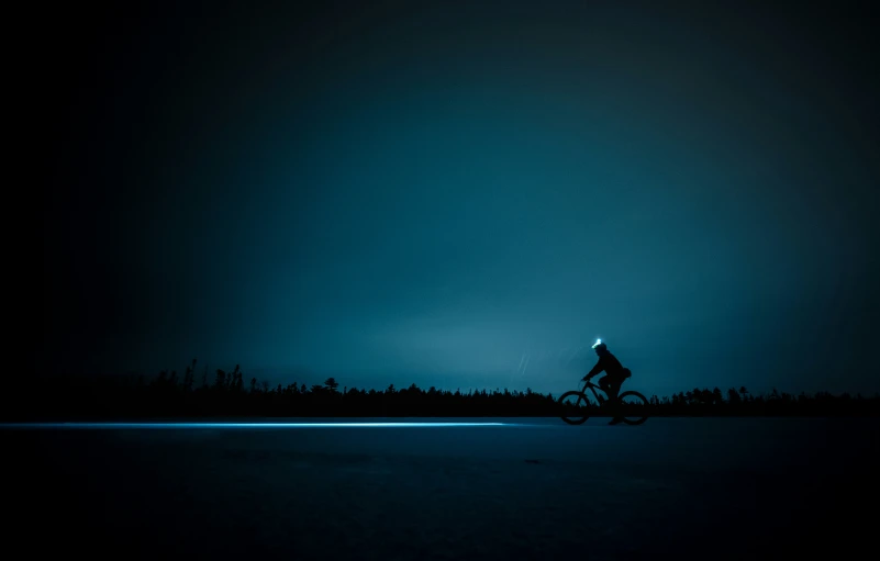 a person on a bike in the dark
