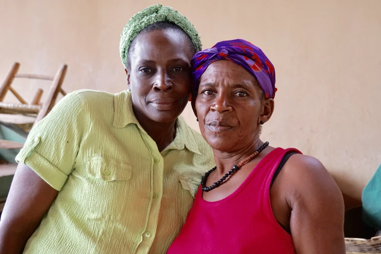 a woman posing for the camera next to an old lady