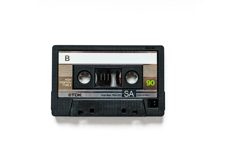 an old, black cassette with the letter s on it