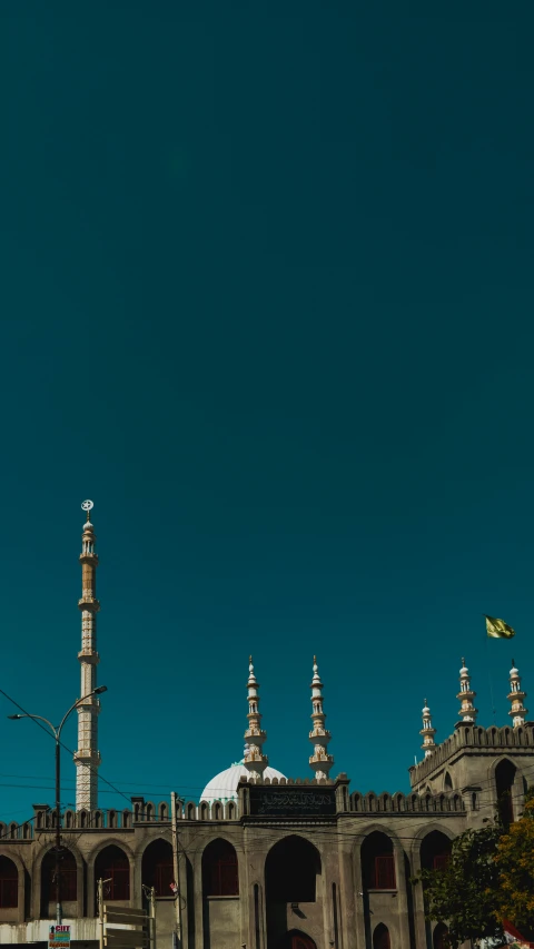 a white and gold building with some very big tower