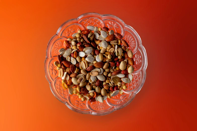 a small bowl full of nuts on top of an orange table