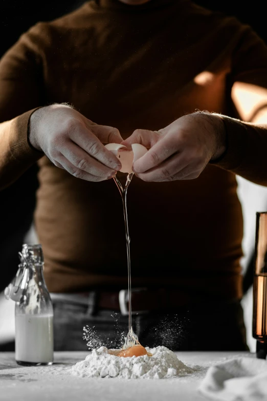 a person pours ingredients on to some type of table