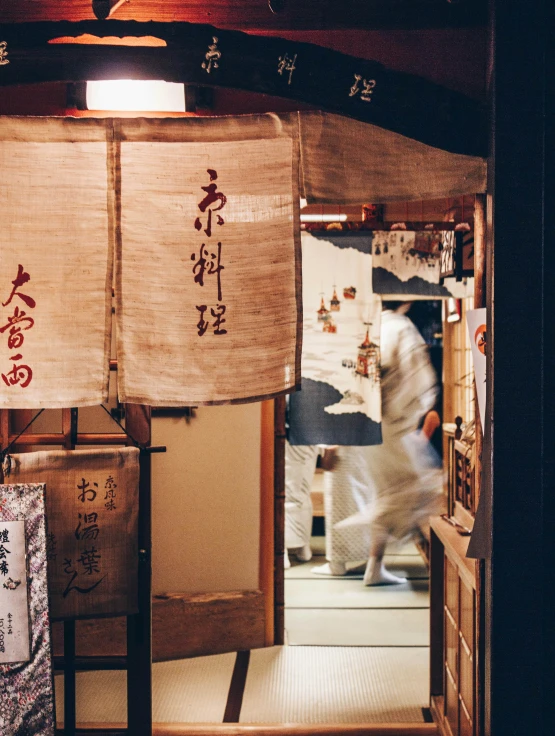 asian themed kitchen with person moving through it