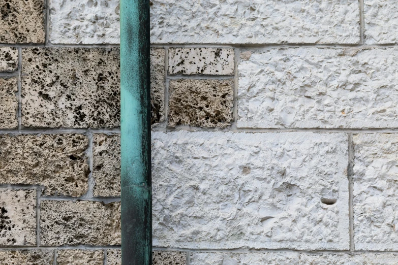 a green pipe that is on top of cement