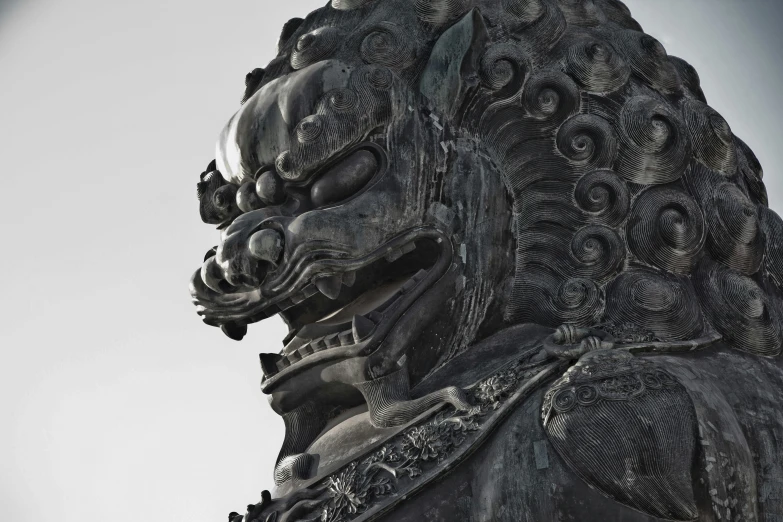 a statue with a large demon face on it's head