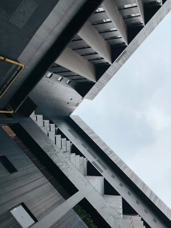 view from the floor looking up at a tall concrete building