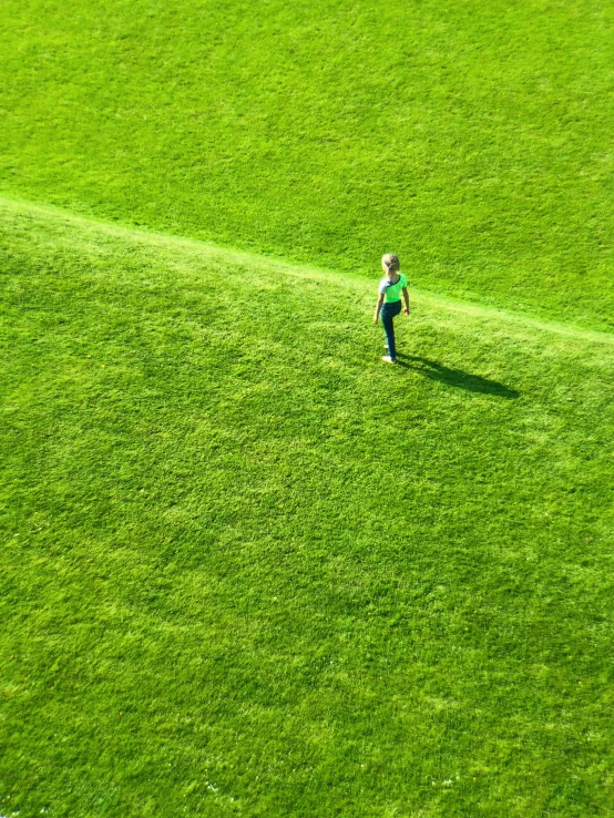 a  walking on the edge of a soccer field