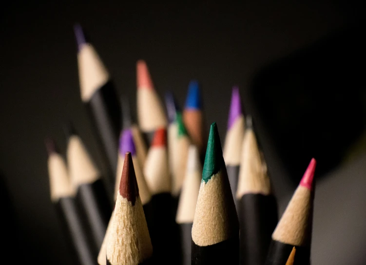 several pairs of pencils sit in a pile on a table