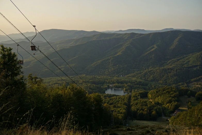 an electrical tower that is above a valley