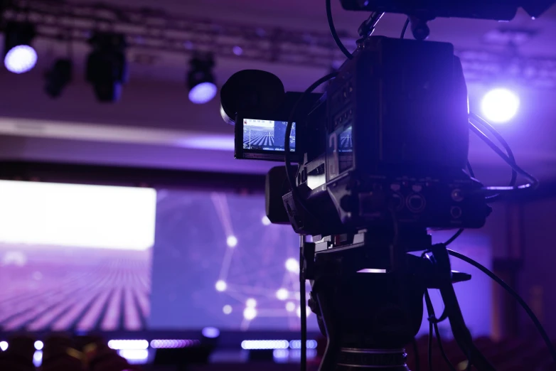 a camera filming a show in the dark room