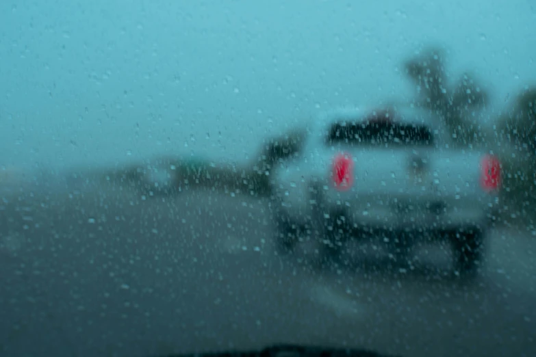 the view out of a window of cars driving down a highway