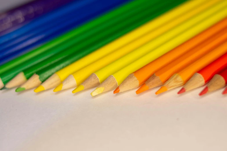 the rainbow colored pencils are lined up neatly