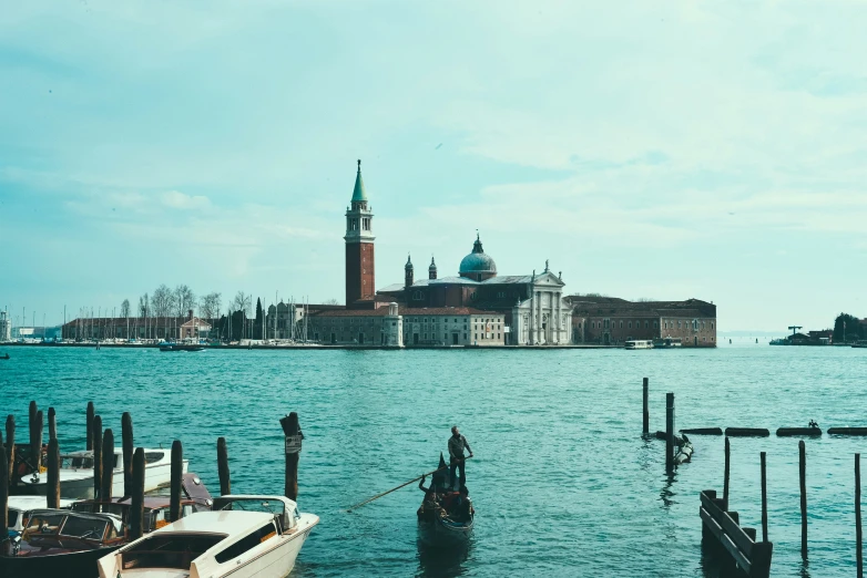 the old town of venice is visible over the blue water