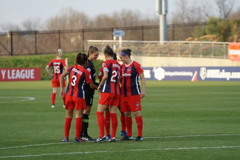 a soccer team gathers around for the ball