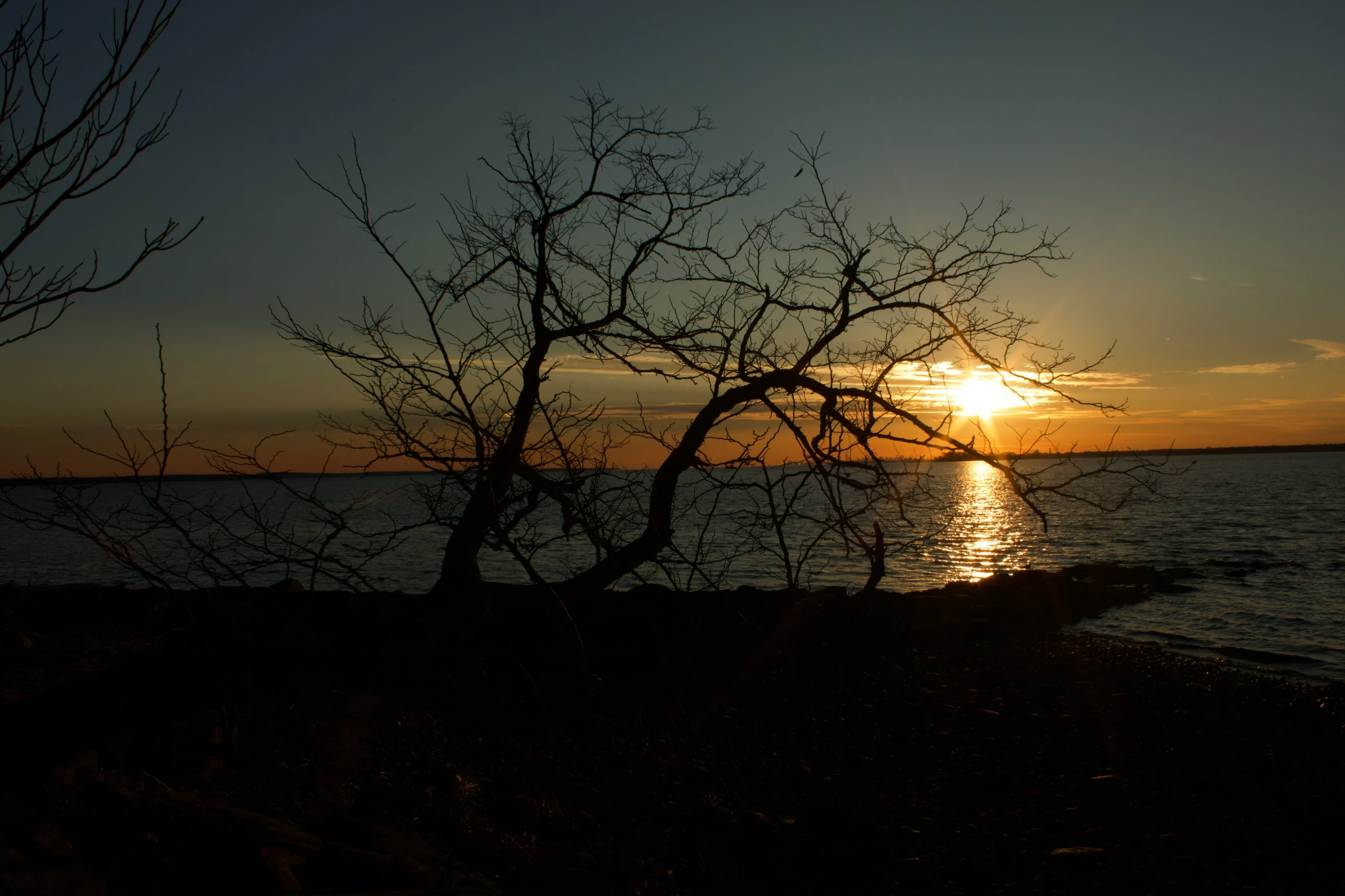 the sun is setting over a body of water