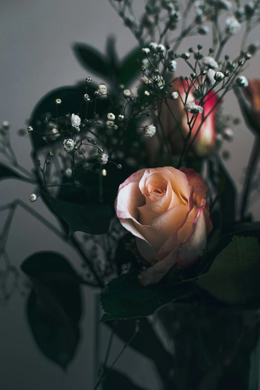 a vase filled with lots of flowers on top of a table