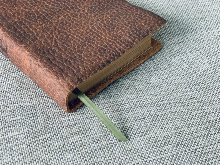 a small book is held up by a rubber band