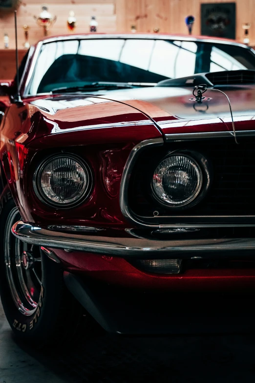 an old, classic mustang sits in a garage