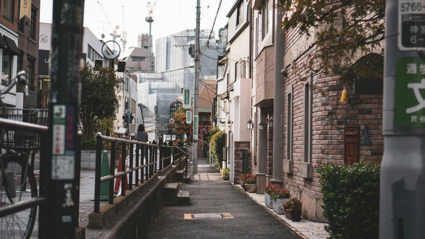 narrow street with city buildings on both sides