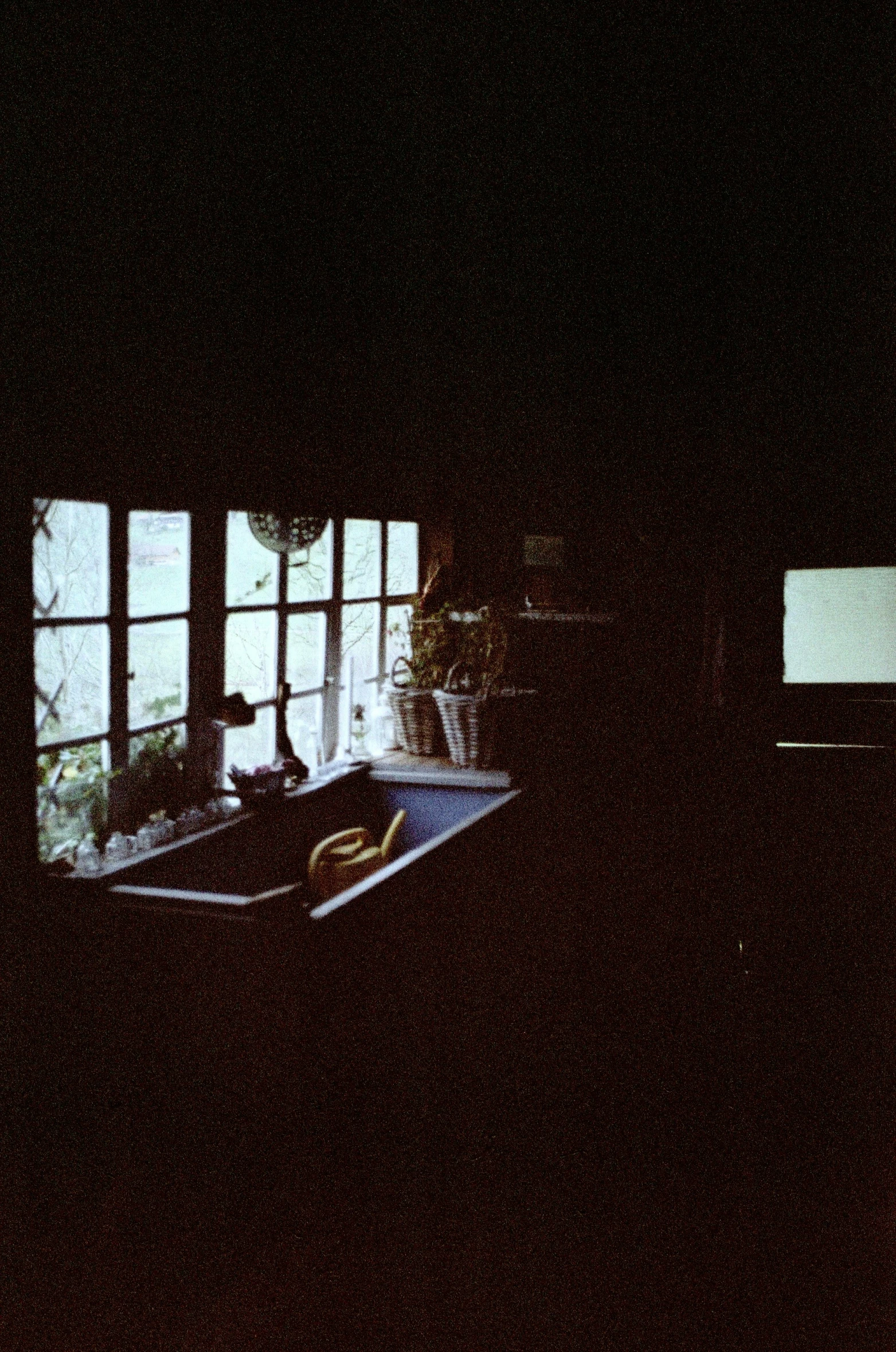 a sink sitting in front of a window in a kitchen