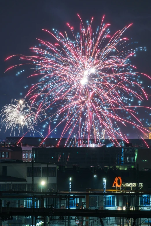 a large crowd watching fireworks in the night sky