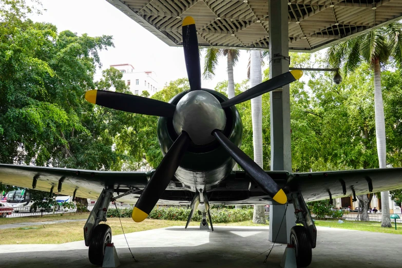 an old style airplane sits underneath the canopy