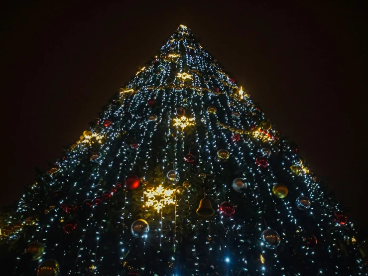 a large christmas tree with lights all around it