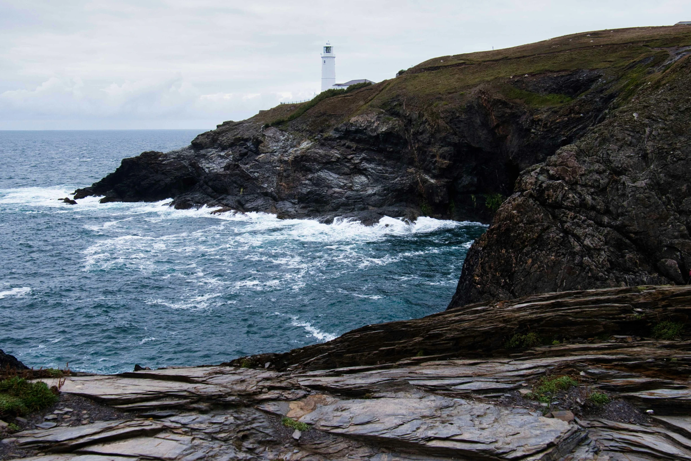 lighthouse with a big wave in the ocean