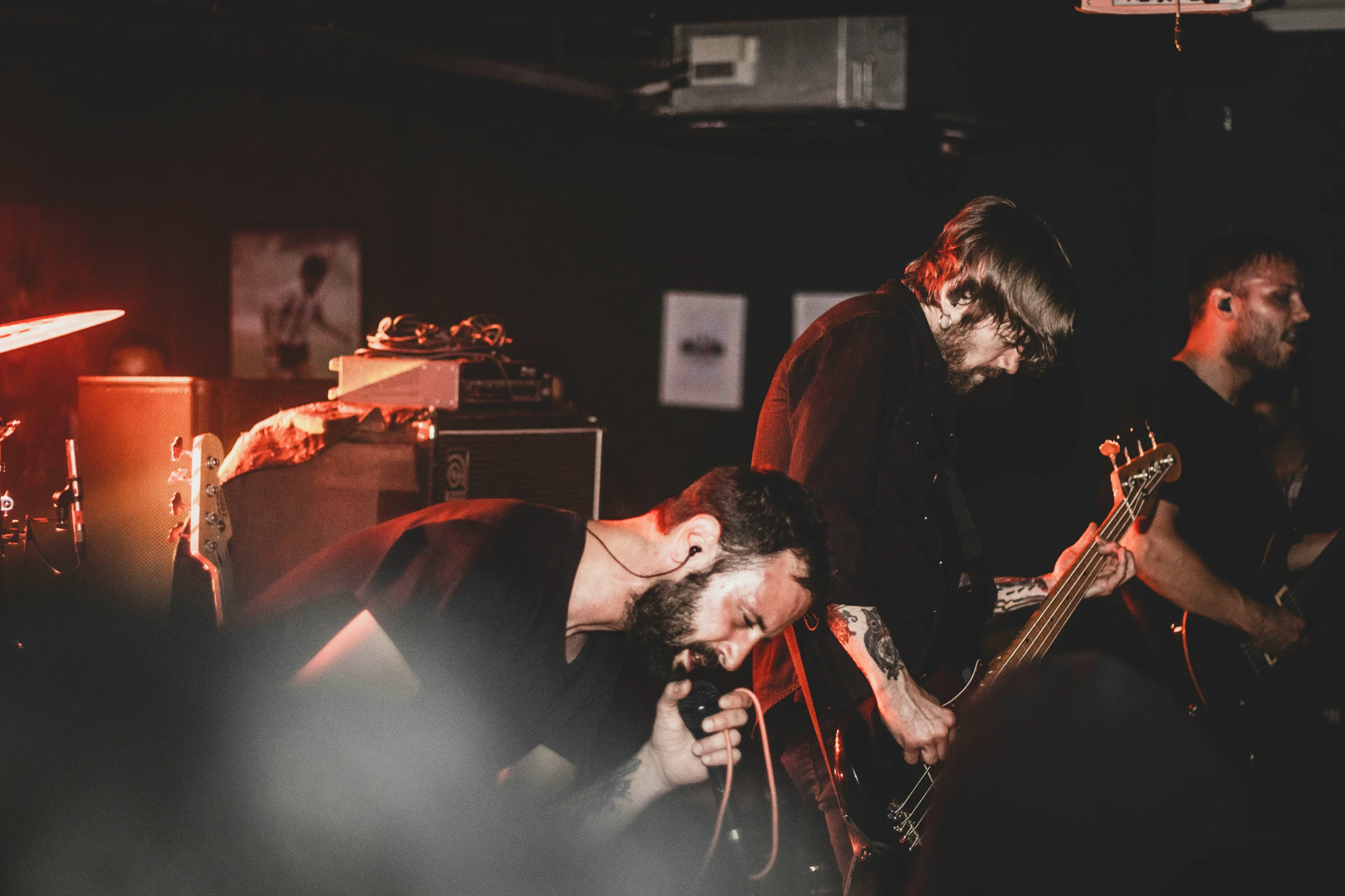 four men standing in front of their guitars