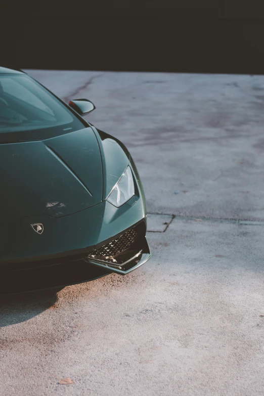 the front view of a green lamb car in a parking lot