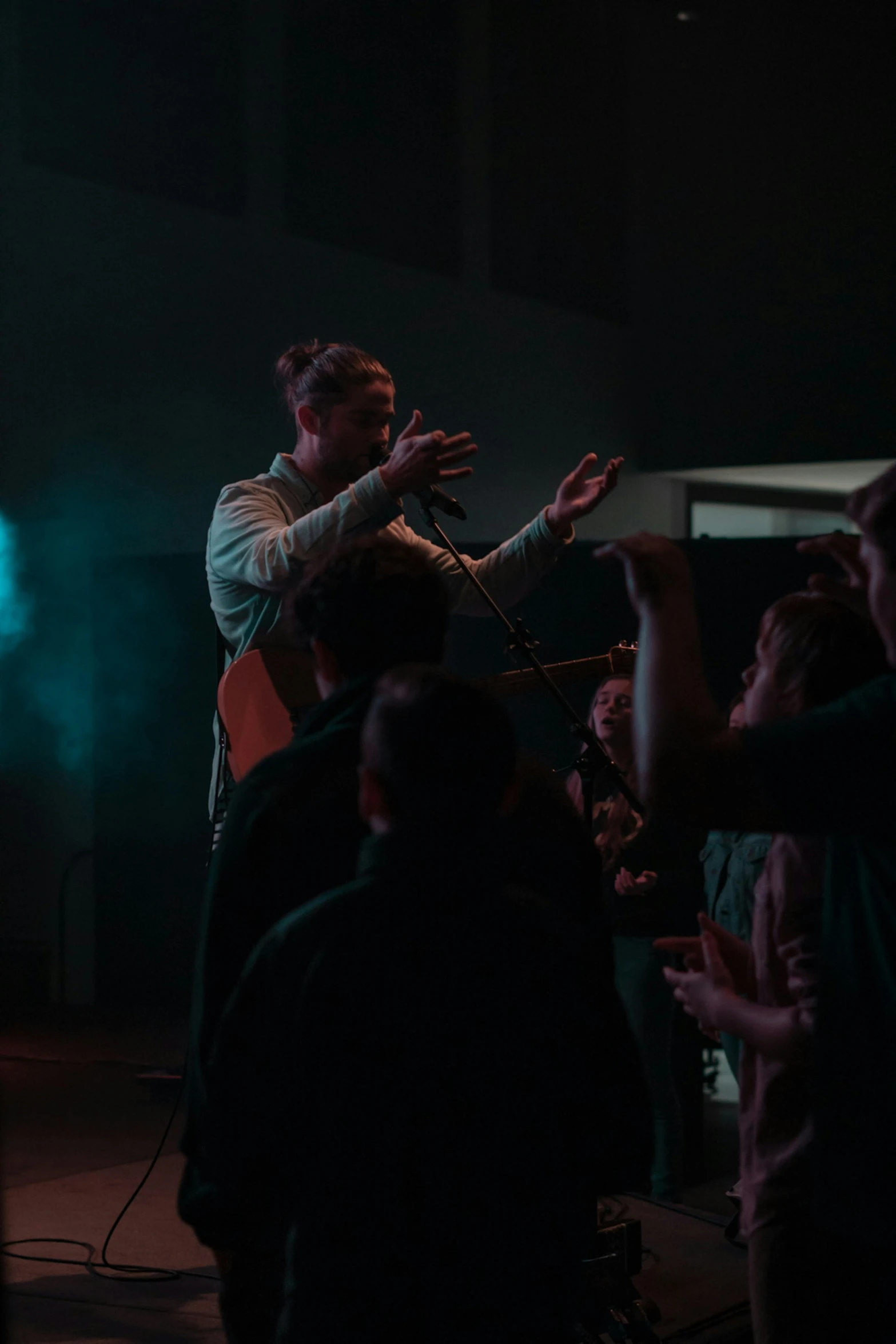 a man standing on a stage with his guitar