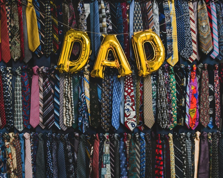 a bunch of ties with letters that spell out dad on them