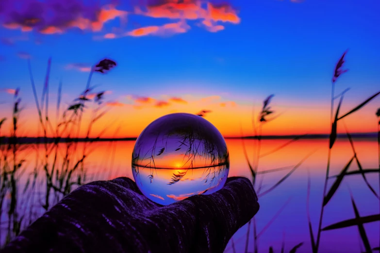 a glass ball that is near the water