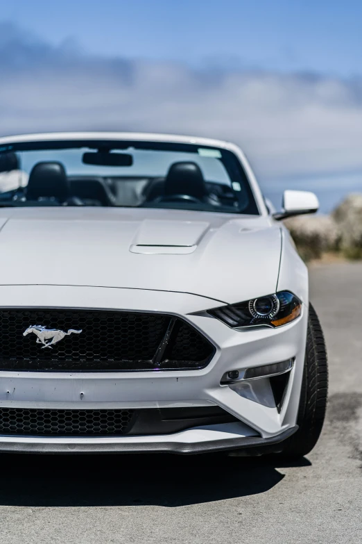 the front end of a silver car with its hood up