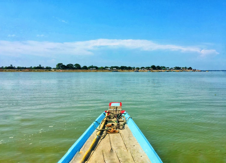 there is a wooden boat that is in the water