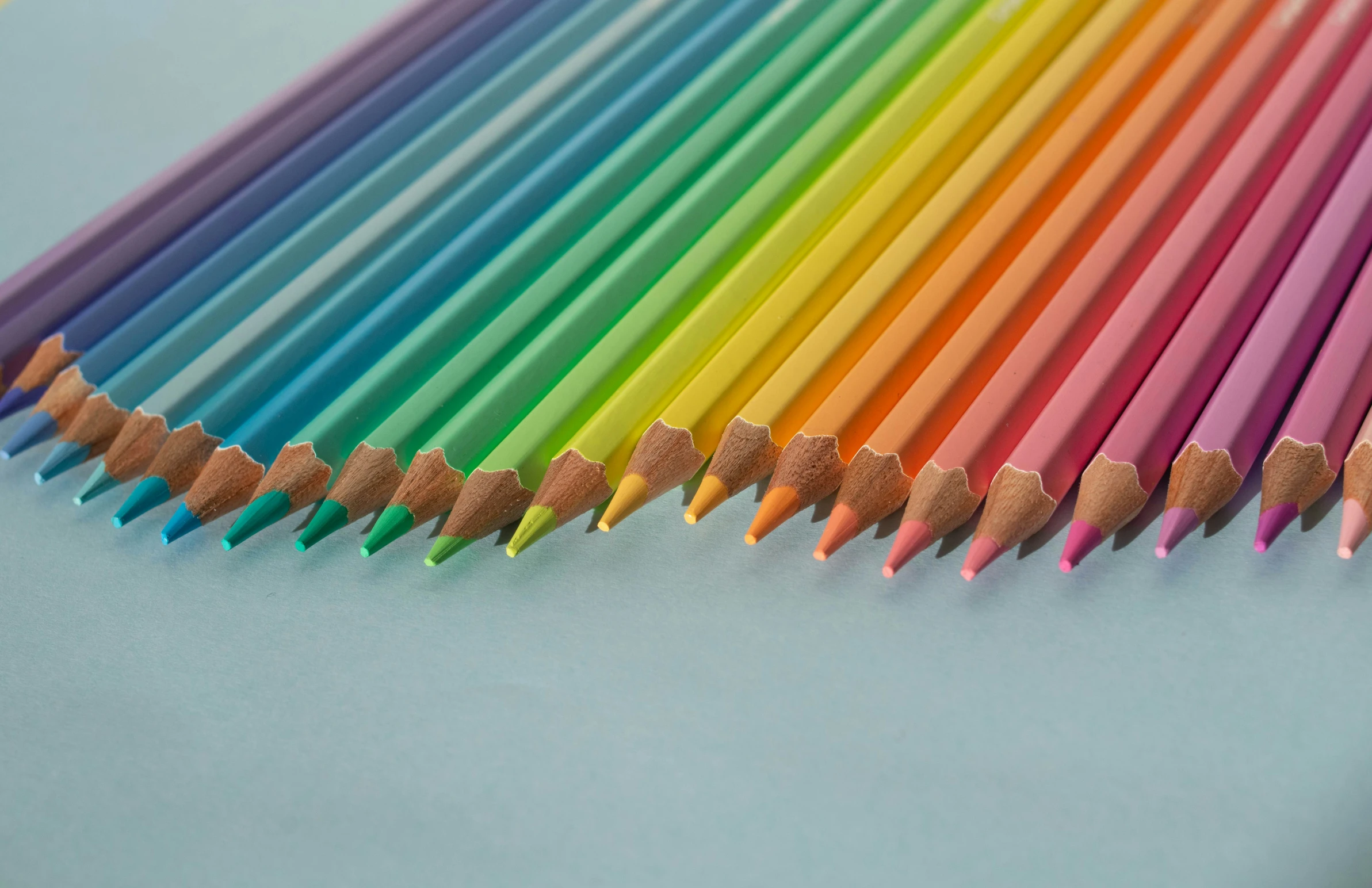 color pencils lined up in a rainbow pattern