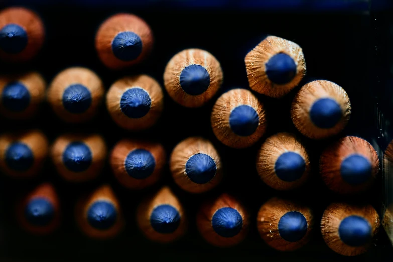 a large group of blue and orange pencils